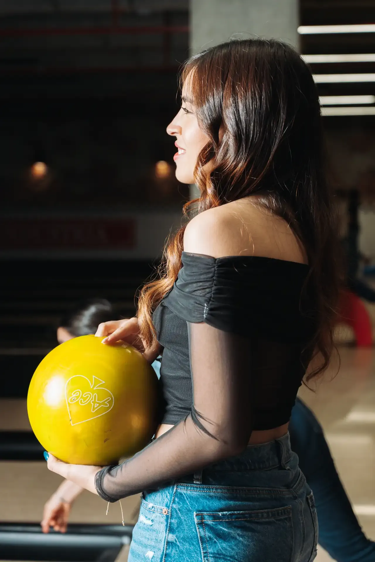 Visitante posa con una bola amarilla en la pista.