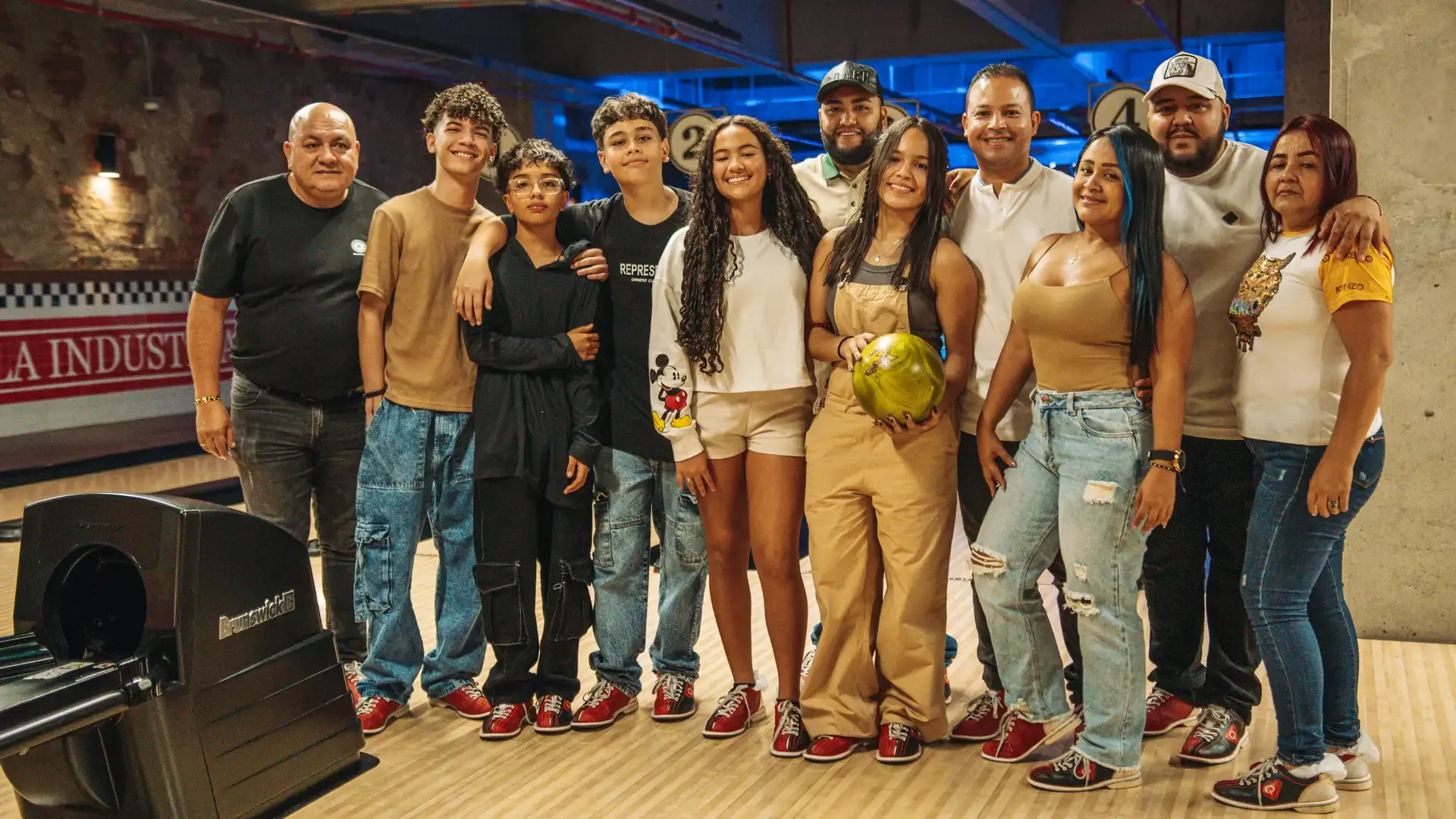 Grupo de amigos posa junto a las pistas de bolos.